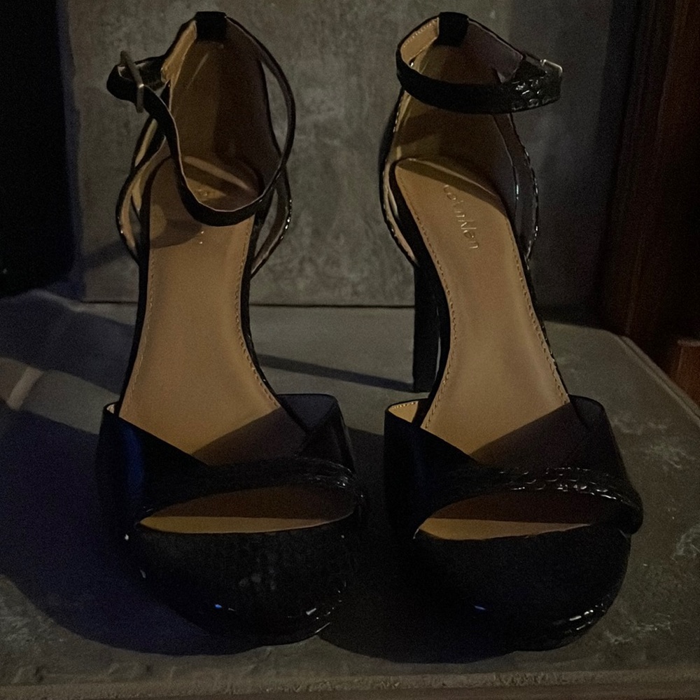 Calvin Klein Black patent leather sandal.